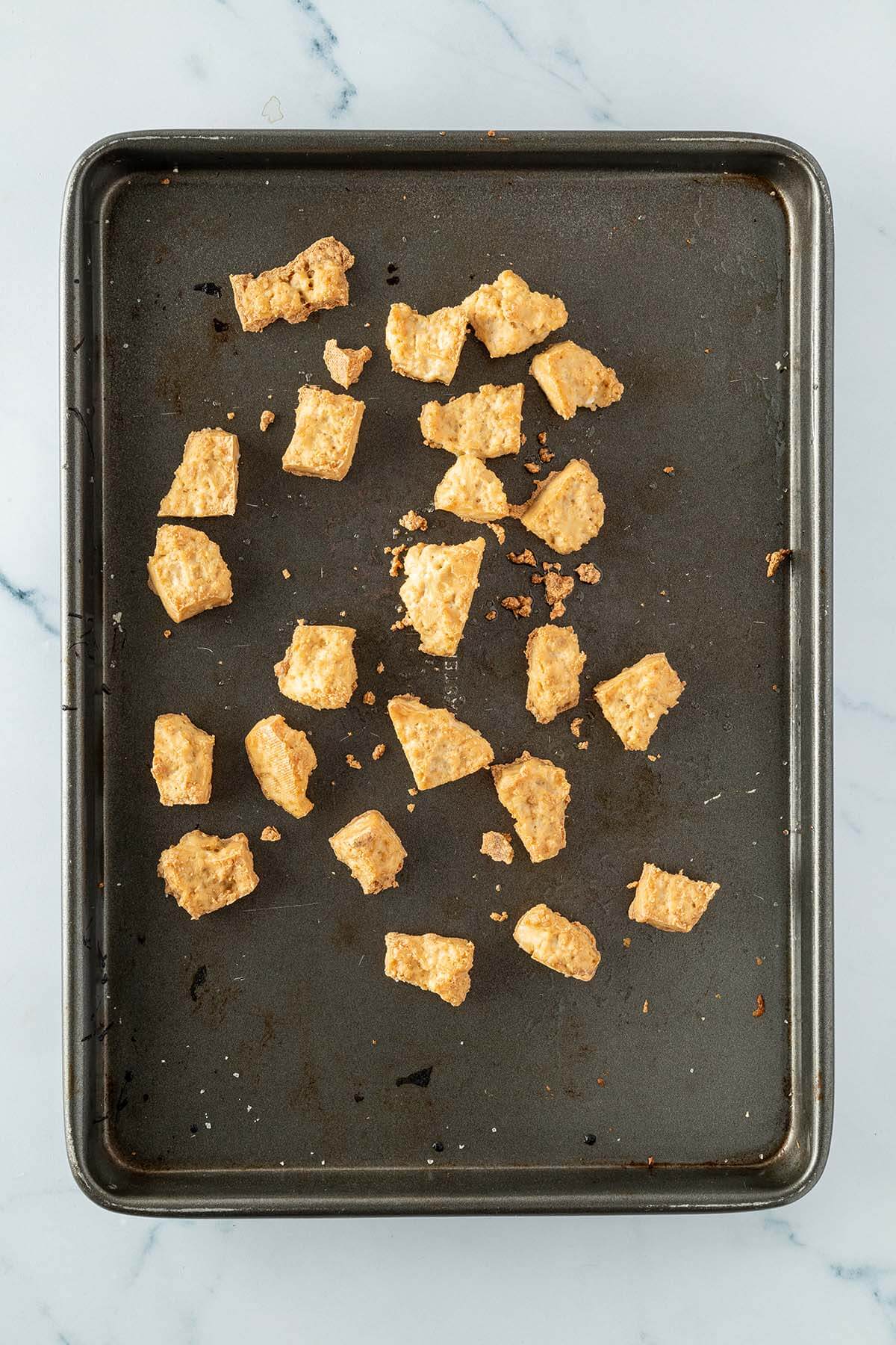 Knusprige Tofust&uuml;cke auf einem Backblech.
