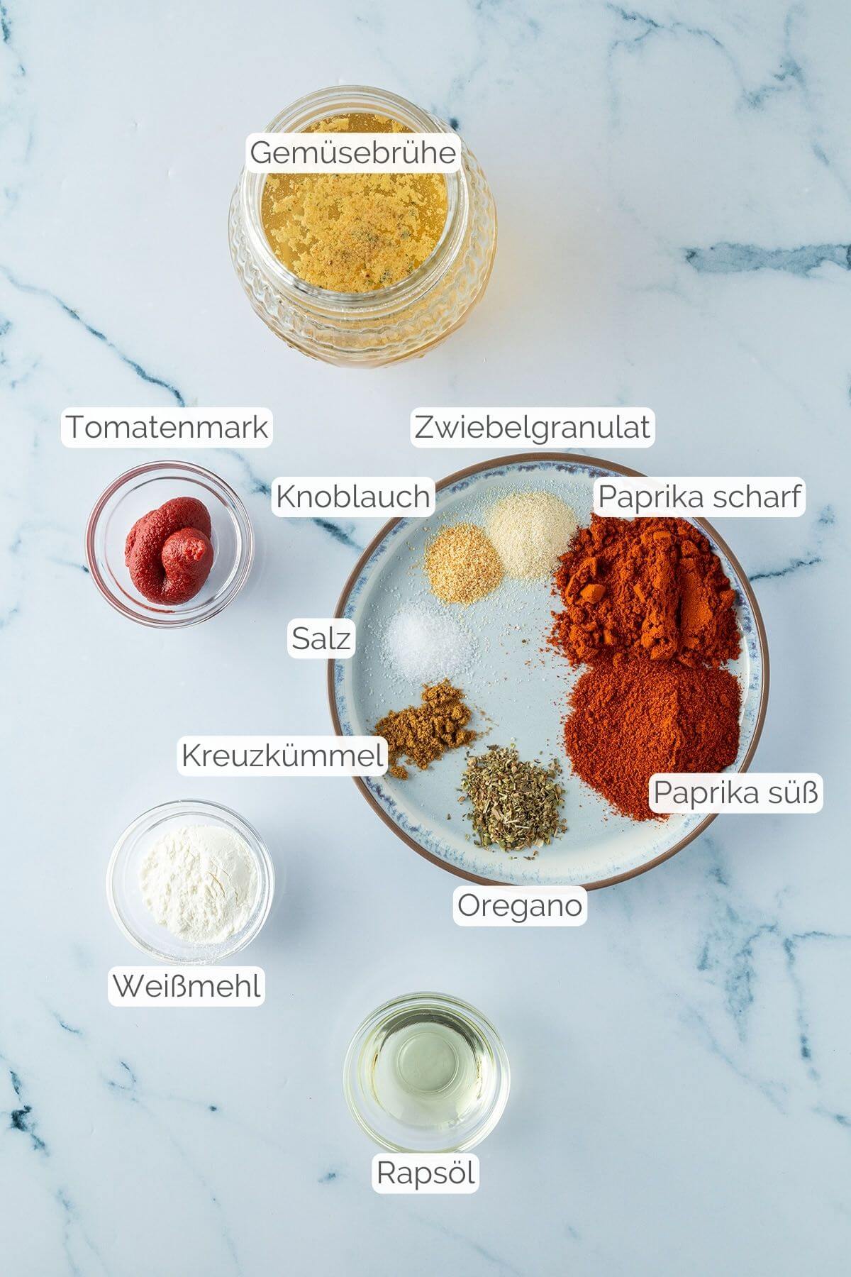 Foto aller Zutaten mit jeweiligen Textbeschriftungen, die f&uuml;r die Enchilada-Sauce ben&ouml;tigt werden.