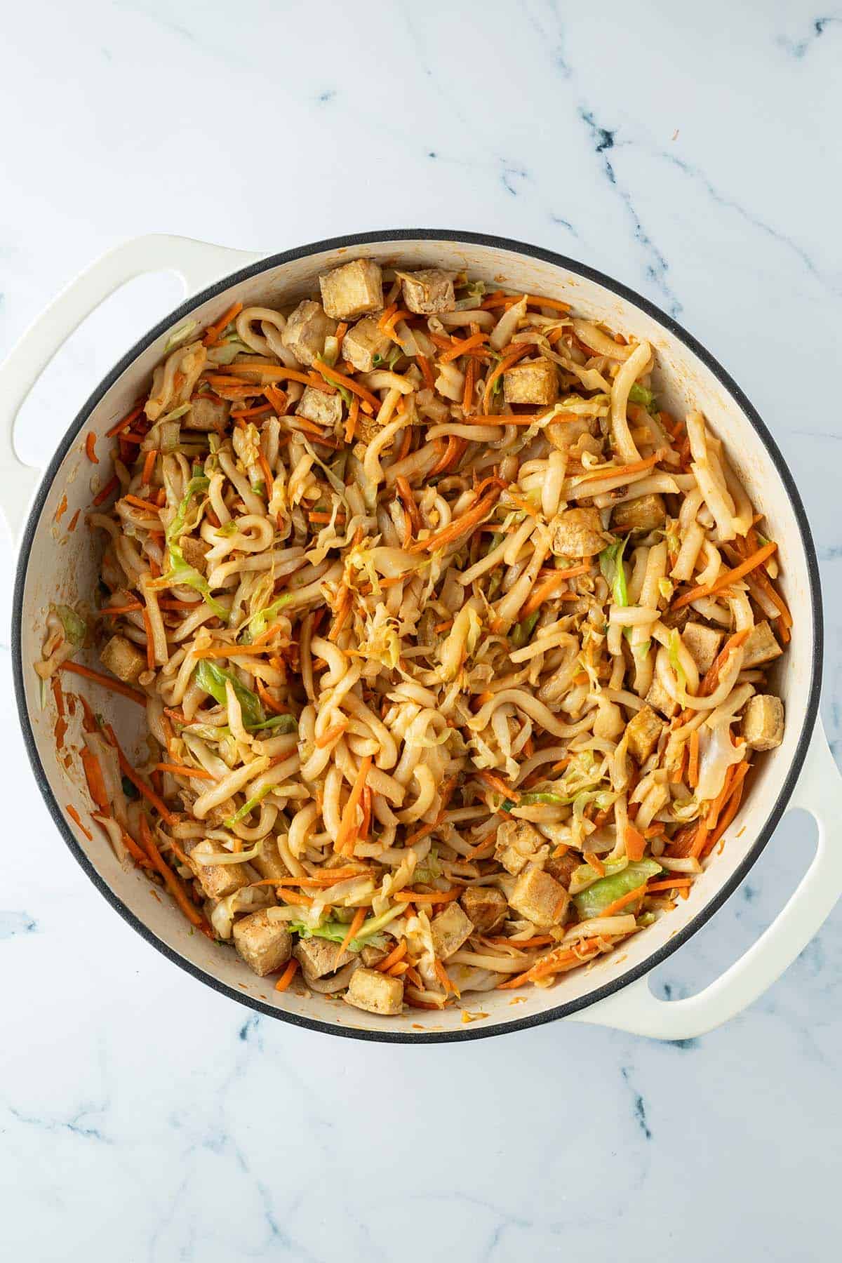 Knusprige Tofuwürfel wurden unter die Udon-Gemüse-Pfanne gemischt.
