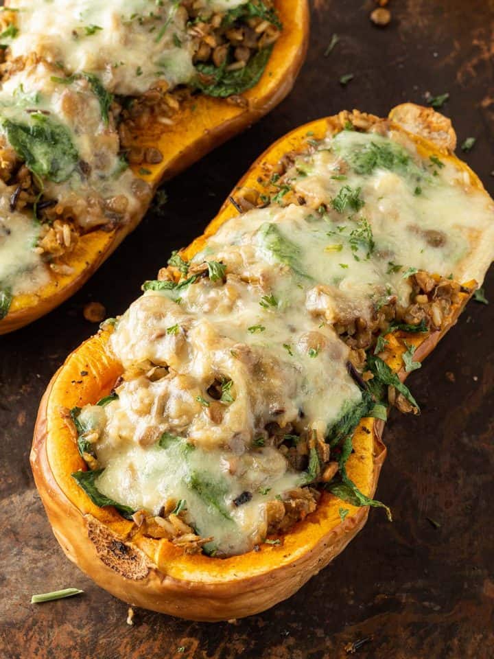 Mit Reis und Linsen gef&uuml;llter Butternut K&uuml;rbis mit geschmolzenem Mozzarella darauf.