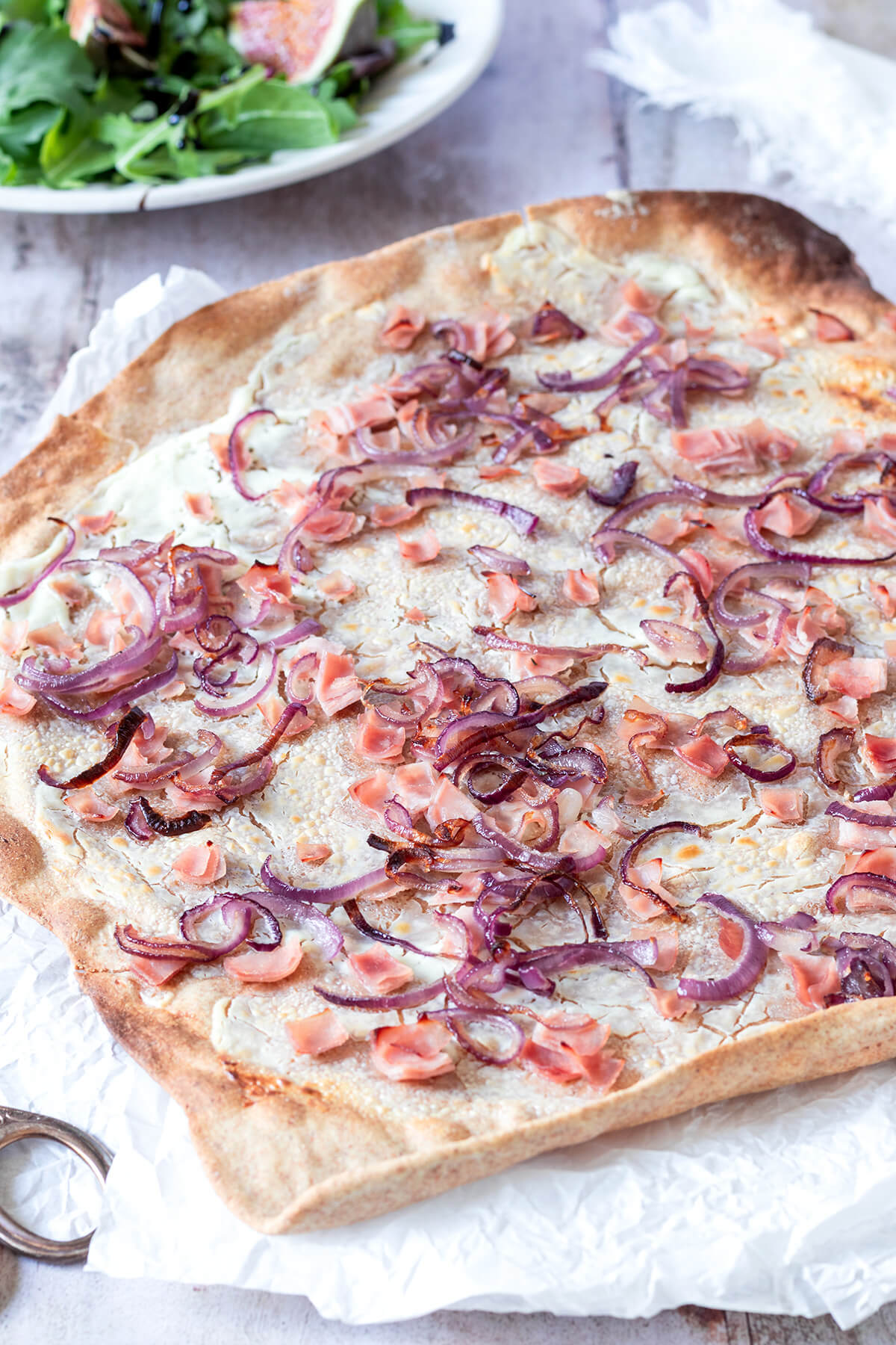 Gesunder Vollkorn Flammkuchen mit Schinken W&uuml;rfel und roten Zwiebeln.
