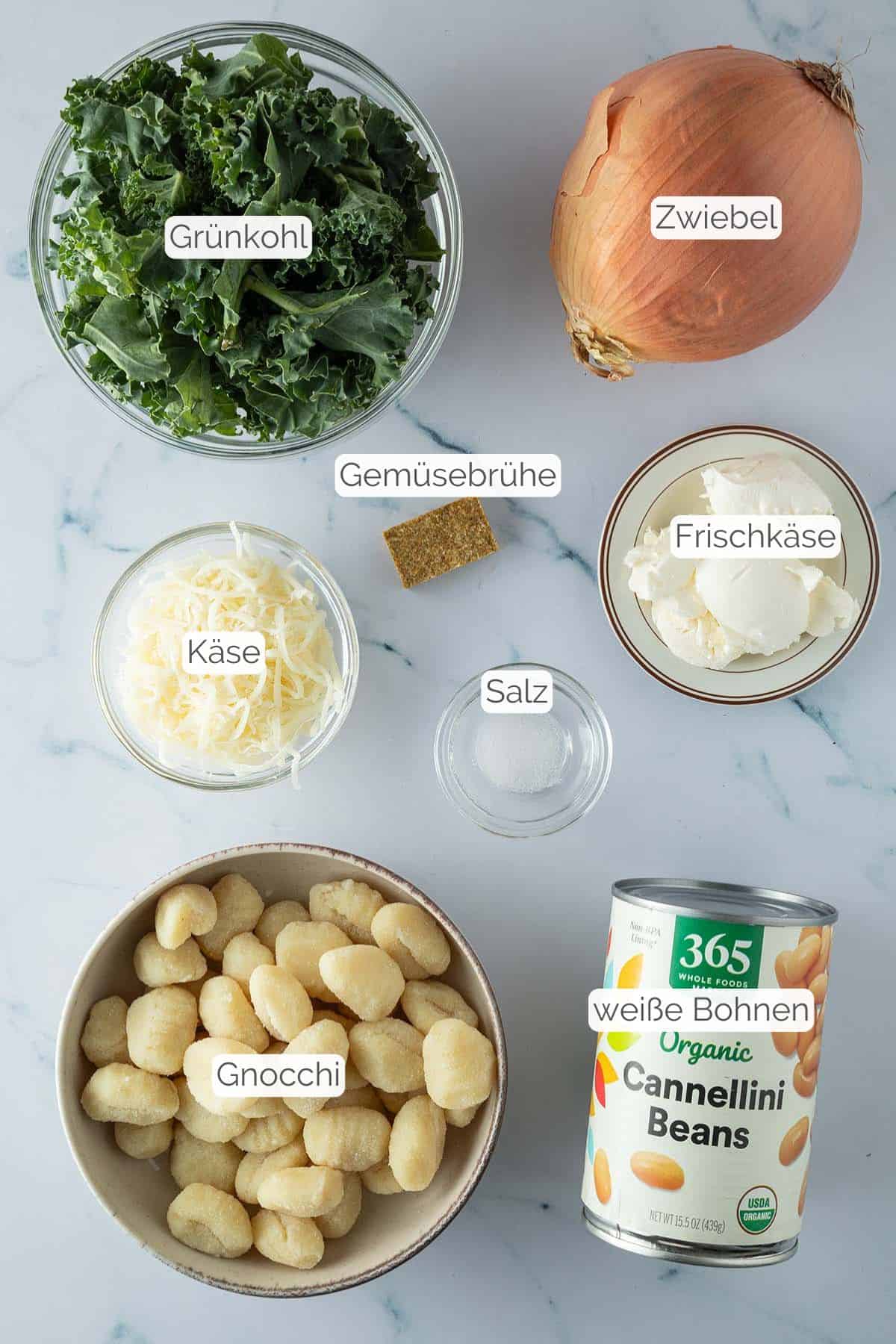 Alle Zutaten mit Textbeschriftungen, die für die Gnocchi Frischkäse Pfanne benötigt werden.