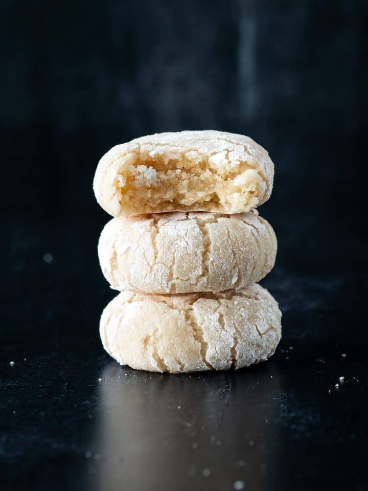 Drei weiche Amaretti Kekse &uuml;bereinander gestapelt, der oberste Keks ist bereits angebissen.