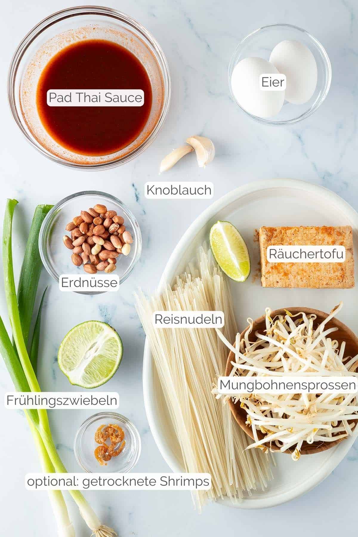 Alle Zutaten mit Textbeschriftungen, die f&uuml;r ein selbstgemachtes Pad Thai mit Tofu ben&ouml;tigt werden.