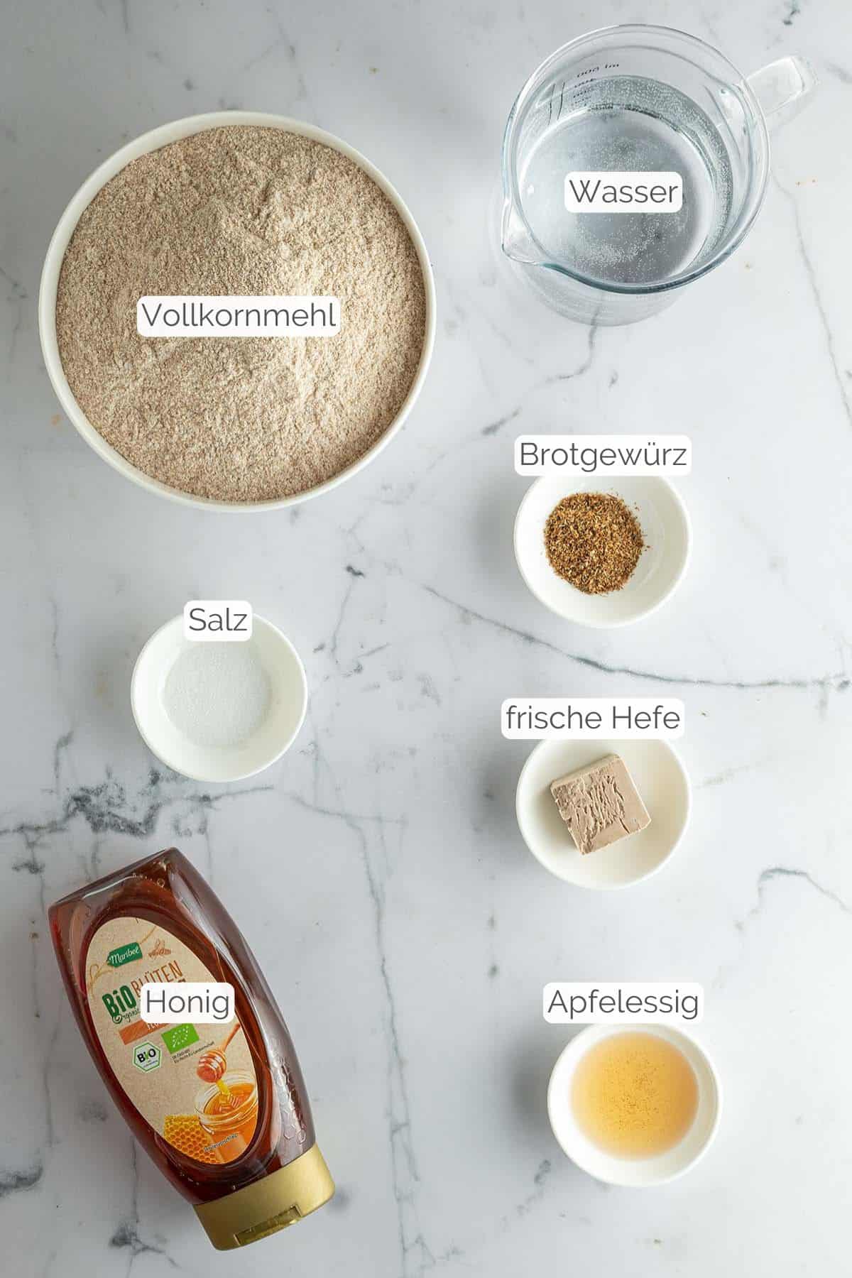 Alle Zutaten mit Textbeschriftungen, die f&uuml;r das Vollkornbrot ohne K&ouml;rner ben&ouml;tigt werden.