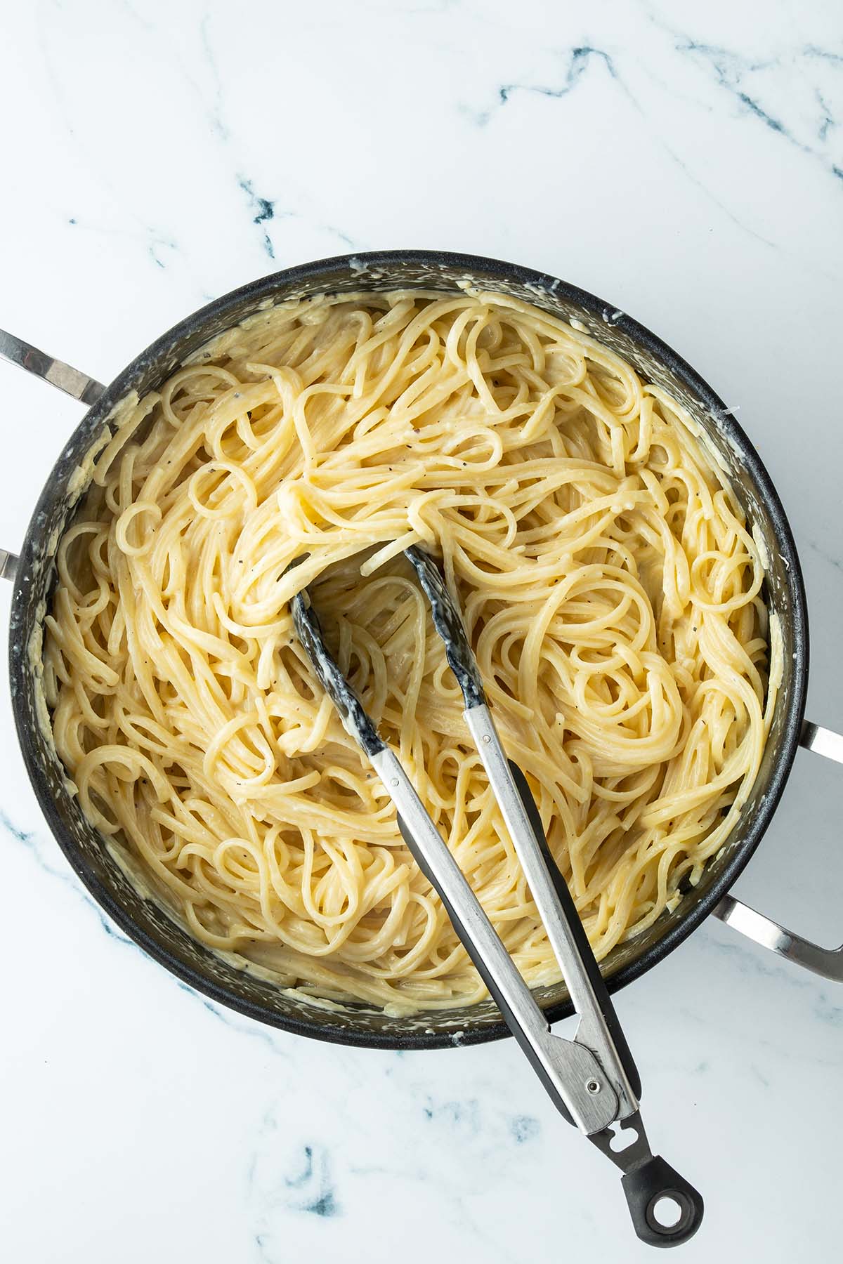 Eine Pfanne mit Linguine in einer cremigen Sauce.
